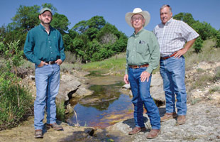 Jule Richmond stands by a spring that feeds into the Pecan Bayou